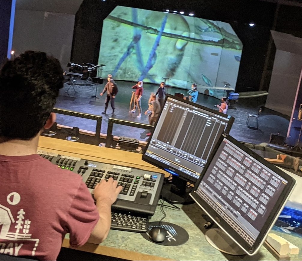 Elijah working at a light board.